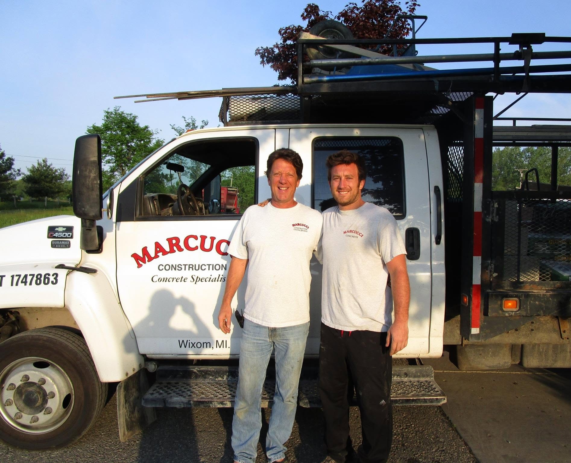 Tom and Tony Marcucci, father and son, in front of their Marcucci Construction truck in Wixom, MI
